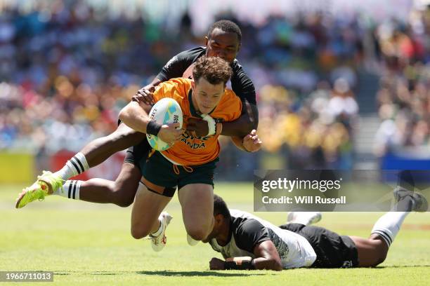 Henry Palmer is tackled during the 2024 Perth SVNS men's cup semi final match between Australia and Fiji at HBF Park on January 28, 2024 in Perth,...