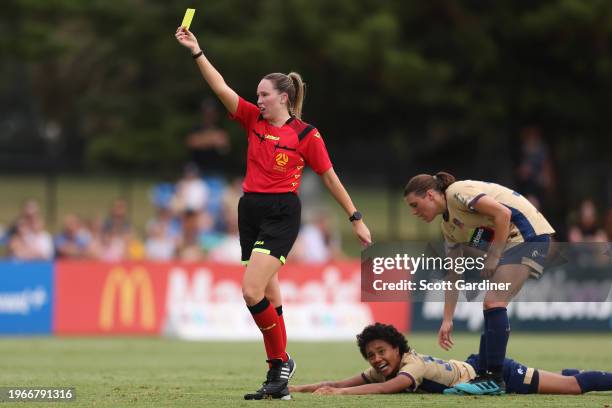 Referee Bec Mackie issues Tiarna Karambasis of the Mariners a yellow card following a tackle on Sarina Bolden of the Jets during the A-League Women...