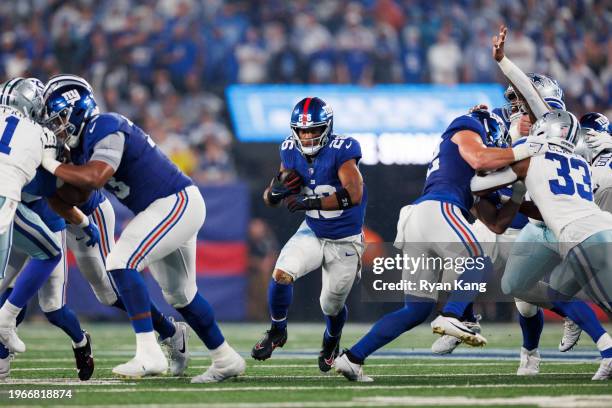Saquon Barkley of the New York Giants carries the ball during an NFL football game against the Dallas Cowboys at MetLife Stadium on September 10,...