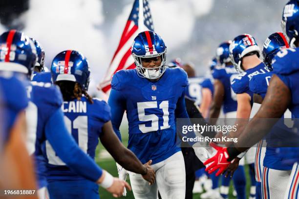 Azeez Ojulari of the New York Giants runs onto the field during player introductions prior to an NFL football game against the Dallas Cowboys at...