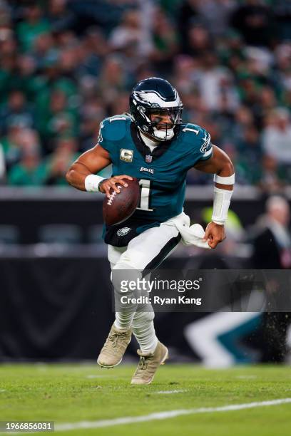 Philadelphia Eagles quarterback Jalen Hurts rolls out and looks to throw a pass during an NFL football game against the Dallas Cowboys at Lincoln...