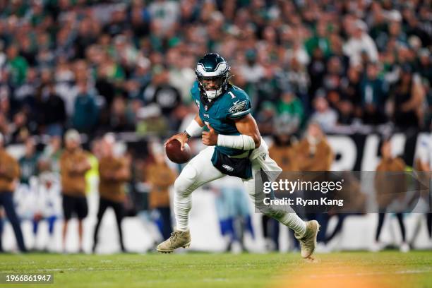 Jalen Hurts of the Philadelphia Eagles rolls out and looks to throw a pass during an NFL football game against the Dallas Cowboys at Lincoln...
