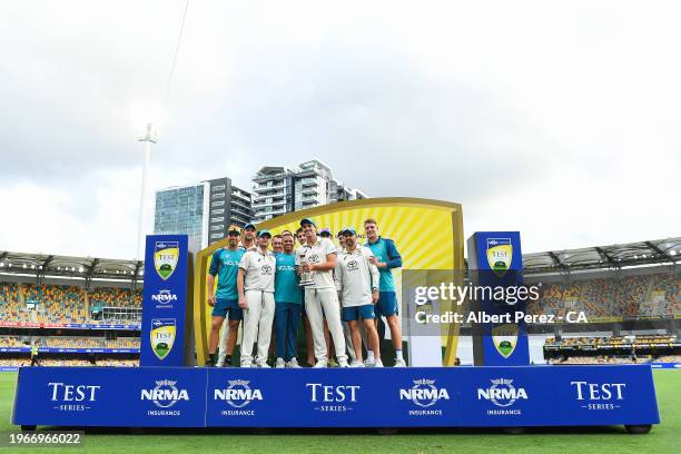 Australia pose in the podium after retaining the trophy during day four of the Second Test match in the series between Australia and West Indies at...