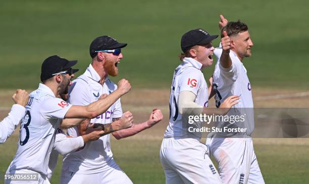 England bowler Joe Root celebrates with team mates after taking the wicket of KL Rahul after a review during day four of the 1st Test Match between...