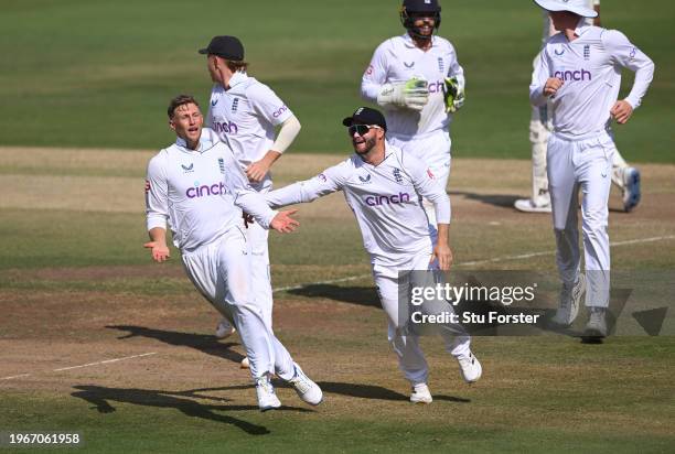 England bowler Joe Root celebrates with team mates after taking the wicket of KL Rahul after a review during day four of the 1st Test Match between...