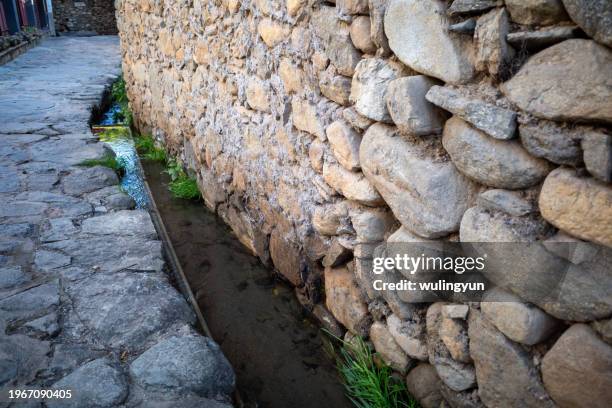 weathered rock wall  with small flowing stream - tiny creek stock pictures, royalty-free photos & images