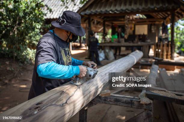 Worker sands a piece of wood in the Black House's Garden. The "Baan Dam Museum", also known as the "Black House" and often referred to as the "Black...