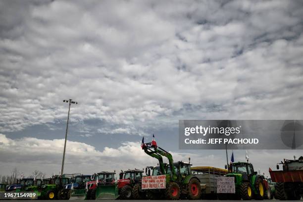 Farmers block the A6 motorway toll, on January 31, 2024 in Villefranche-sur-Saône, near Lyon, amid nationwide protests called by several farmers...