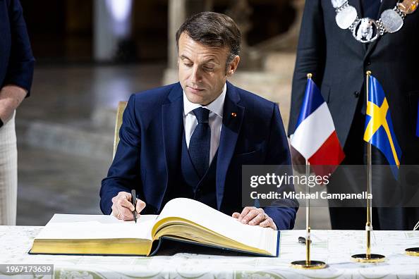 Macron Sign France's President Emmanuel Macron signs a guestbook while attending ...