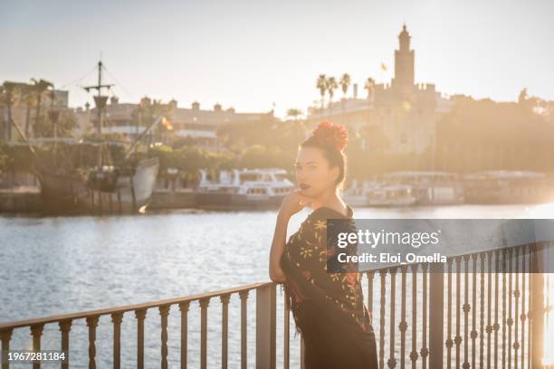 woman with manton de manila (manila shawl) in front of torre del oro in seville - white shawl stock pictures, royalty-free photos & images