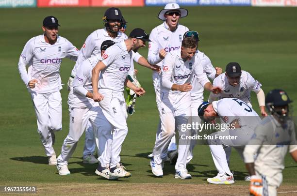 England captain Ben Stokes celebrates with team mates after his throw had run out India batsman Ravindra Jadeja during day four of the 1st Test Match...