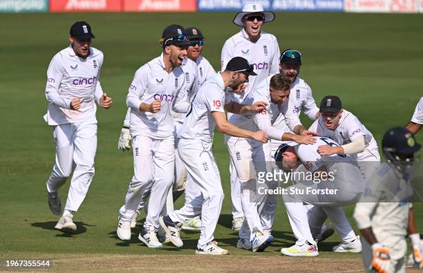 England captain Ben Stokes celebrates with team mates after his throw had run out India batsman Ravindra Jadeja during day four of the 1st Test Match...