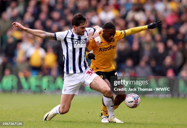 Jean-Ricner Bellegarde of Wolverhampton Wanderers is challenged by Okay Yokuslu of West Bromwich Albion during the Emirates FA Cup Fourth Round match...