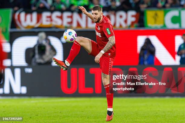 Jeff Chabot of 1. FC Köln plays the ball during the Bundesliga match between VfL Wolfsburg and 1. FC Köln at Volkswagen Arena on January 27, 2024 in...