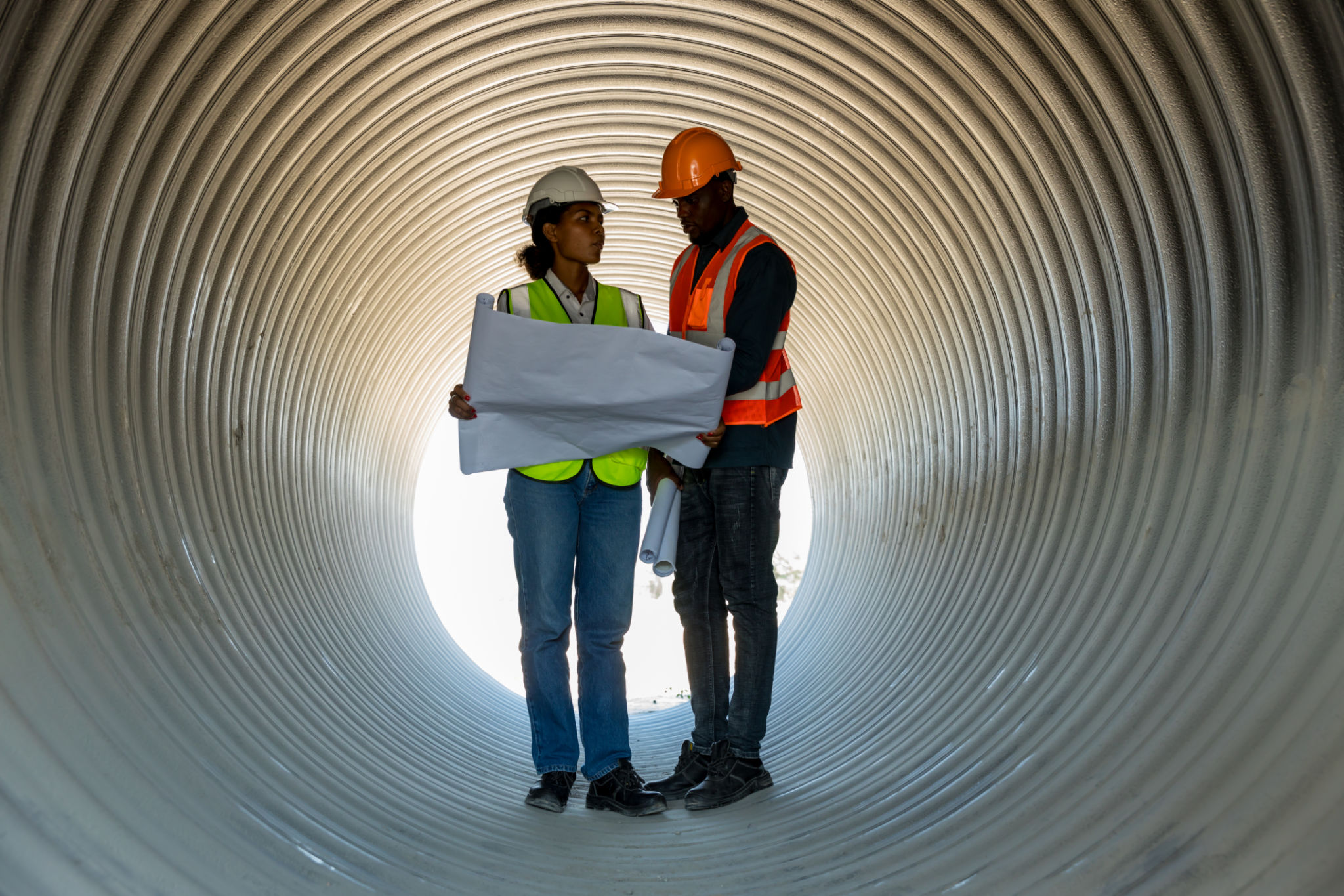Industry Engineers Walking Inside Circular water Pipe. Engineering or Worker inspection pipe circular. Checking Construction of the water, Oil Natural Gas and fuels Transport Pipeline. Industry Engineers Walking Inside Circular water Pipe. Engineering or Worker inspection pipe circular. Checking Construction of the water, Oil Natural Gas and fuels Transport Pipeline.