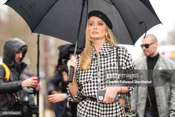 Tatiana Korsakova wears a black beret hat, a black and white checkered jacket, outside Chanel, during the Haute Couture Spring/Summer 2024 as part of...
