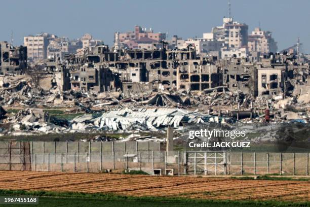 Destroyed buildings in the Gaza Strip are pictured from a position along the border with southern Israel on January 31, 2024 amid the ongoing...