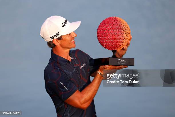 Thorbjorn Olesen of Denmark celebrates victory with the trophy on the 18th green during Day Four of the Ras Al Khaimah Championship at Al Hamra Golf...