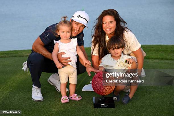 Thorbjorn Olesen of Denmark and his family celebrate victory with the trophy on the 18th green during Day Four of the Ras Al Khaimah Championship at...