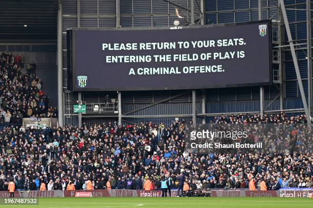 General view inside the stadium as the scoreboard reads "Please return to your seats. Entering the field of play is a criminal offence." during the...