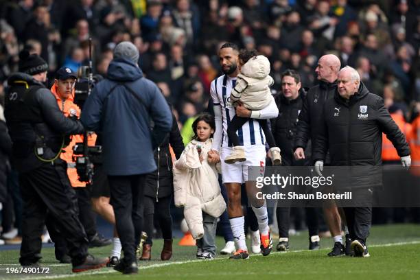 Kyle Bartley of West Bromwich Albion leaves the pitch with his children as the game is suspended due to fans invading the pitch following the...