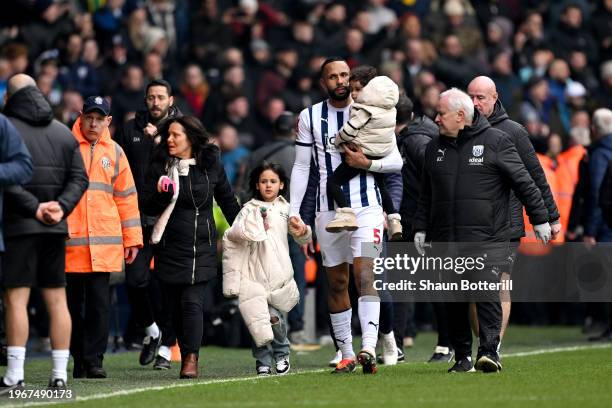 Kyle Bartley of West Bromwich Albion leaves the pitch with his children as the game is suspended due to fans invading the pitch following the...