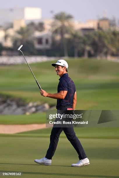 Thorbjorn Olesen of Denmark raises his putter as he celebrates victory on the 18th green during Day Four of the Ras Al Khaimah Championship at Al...