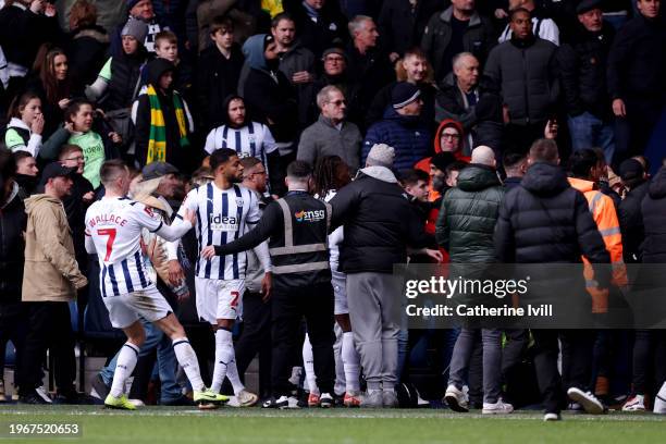 Players of West Bromwich Albion watch on as stewards and local police officers attempt to stop a pitch invasion during the Emirates FA Cup Fourth...