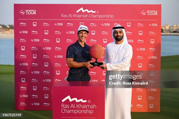 Thorbjorn Olesen of Denmark is awarded the trophy by His Highness Sheikh Ahmed Bin Saud Bin Saqr Al Qasimi on the 18th green during Day Four of the...