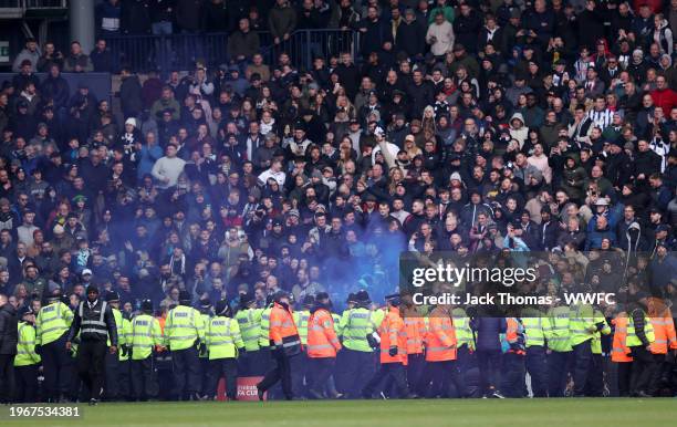 Local police officers attempt to stop a pitch invasion during the Emirates FA Cup Fourth Round match between West Bromwich Albion and Wolverhampton...