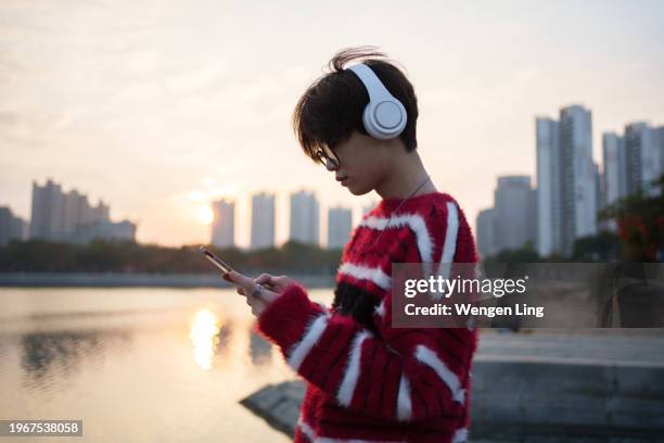 young man using tablet near water - xiamen stock pictures, royalty-free photos & images