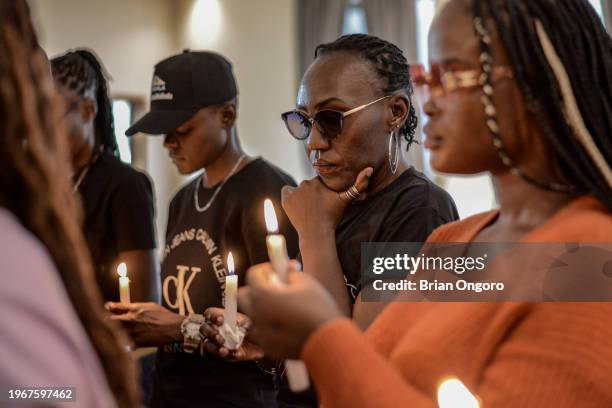 Activists hold candles during a vigil to honour and remember victims of femicide on January 28, 2024 in Kisumu, Kenya. Kenya has been experiencing a...