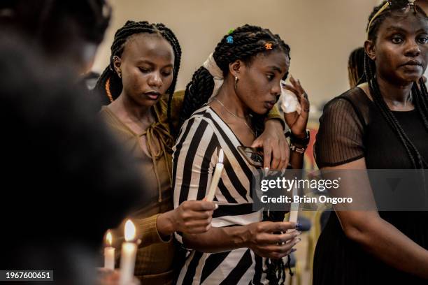 An activist is comforted by a friend during a vigil to honour and remember victims of femicide on January 28, 2024 in Kisumu, Kenya. Kenya has been...