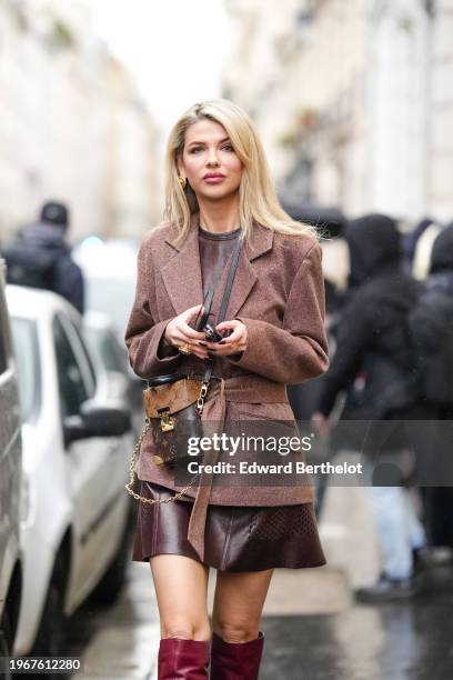 Guest wears a blazer jacket a brown leather Vuitton bag, a brown leather mini skirt, outside Georges Hobeika, during the Haute Couture Spring/Summer...