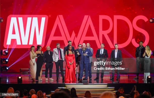 Kira Noir and Ricky Greenwood accept the Grand Reel award for "Machine Gunner" as presenters Jason Luv and Abella Danger look on during the 2024...