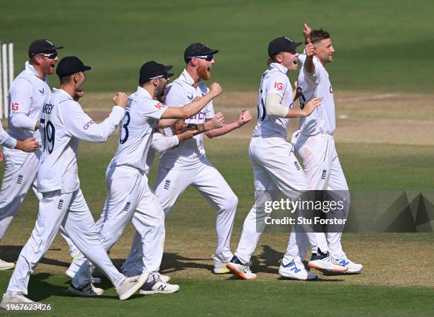 England bowler Joe Root celebrates with team mates after taking the wicket of KL Rahul after a review during day four of the 1st Test Match between...