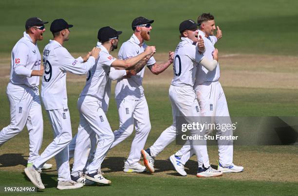 England bowler Joe Root celebrates with team mates after taking the wicket of KL Rahul after a review during day four of the 1st Test Match between...