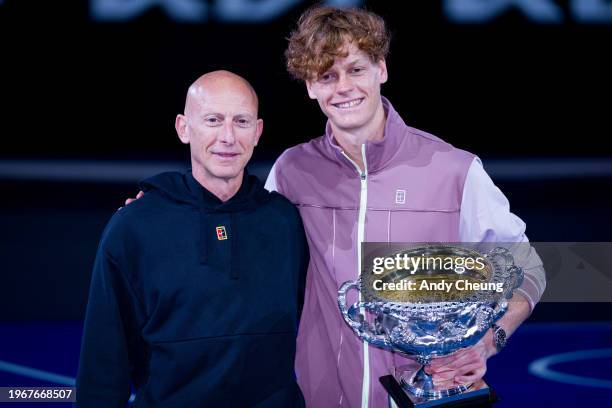 Jannik Sinner of Italy and fitness coach Umberto Ferrara pose with the Norman Brookes Challenge Cup during the official presentation after their...