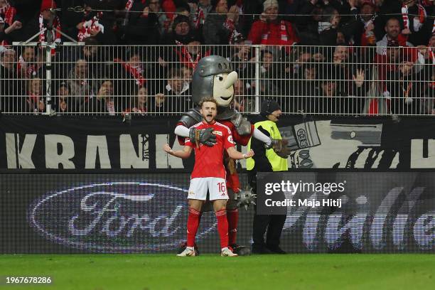 Benedict Hollerbach of 1.FC Union Berlin celebrates with Ritter Keule, mascot of 1.FC Union Berlin, after scoring his team's first goal during the...