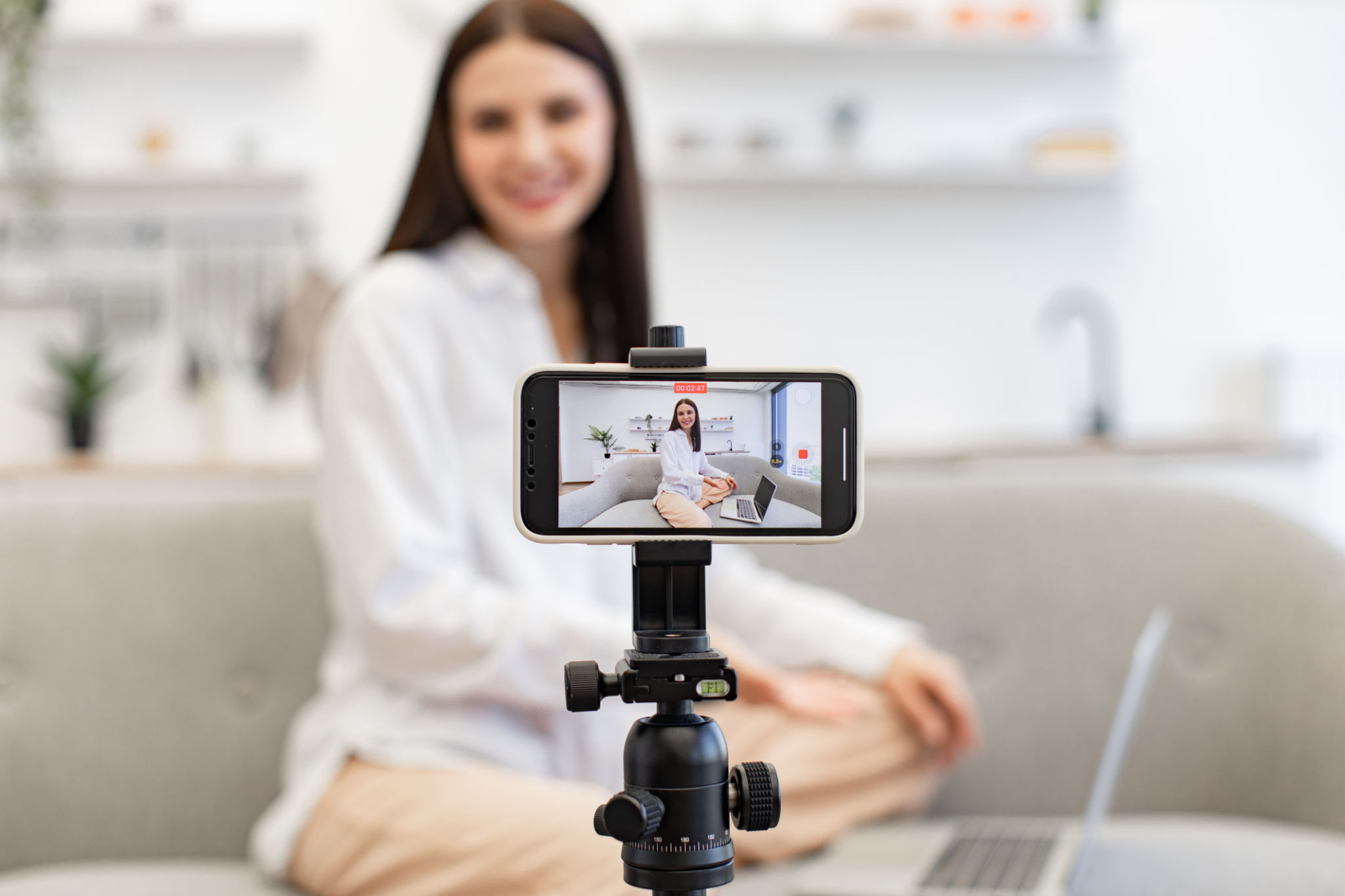 Demanding tutor using modern smartphone with tripod for online training. Demanding tutor using modern smartphone with tripod for online training.