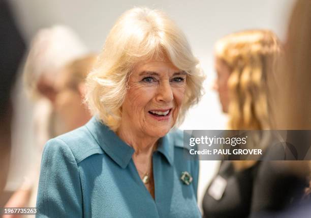 Britain's Queen Camilla talks with volunteers and visitors to the centre after officially opening 'Maggie's Royal Free', a new cancer support centre,...