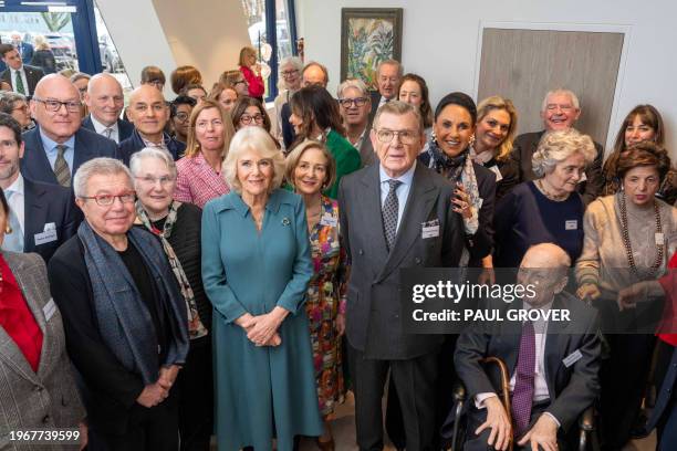 Britain's Queen Camilla poses for a group photograph alongside Gerald Ronson, after officially opening 'Maggie's Royal Free', a new cancer support...