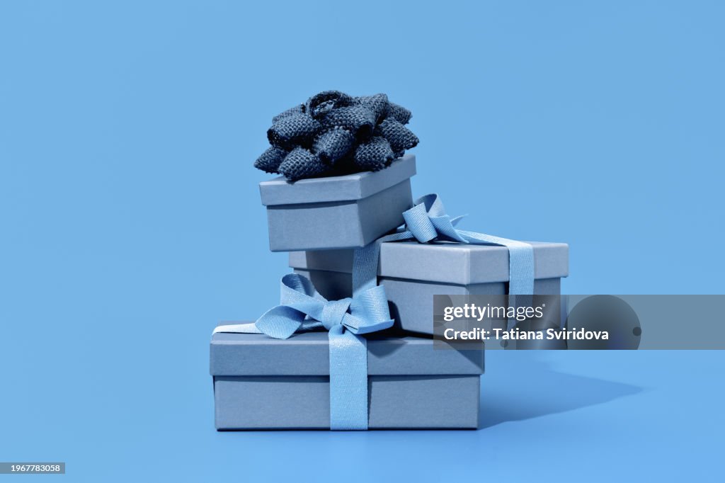 Blue gift boxes with bow ribbon on blue background