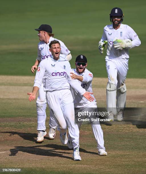 England bowler Joe Root celebrates with team mates after taking the wicket of KL Rahul after a review during day four of the 1st Test Match between...