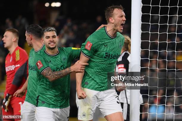 Dan Burn of Newcastle United celebrates with team mate Bruno Guimaraes after scoring his team's second goal during the Emirates FA Cup Fourth Round...