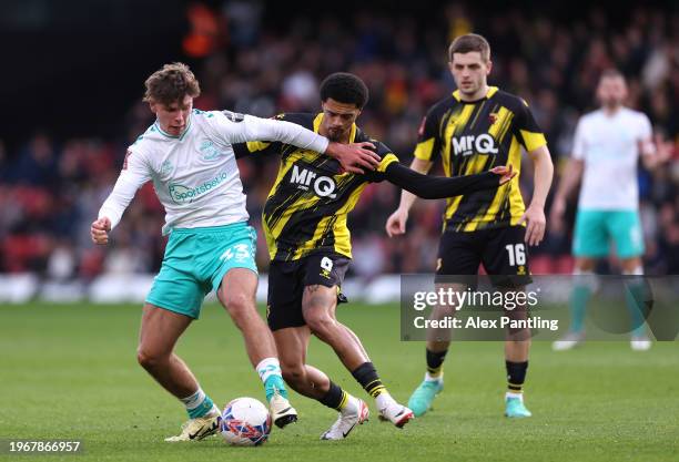 Tyler Dibling of Southampton is tackled by Jamal Lewis of Watford during the Emirates FA Cup Fourth Round match between Watford and Southampton at...