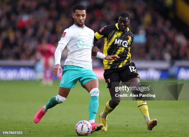 Mason Holgate of Southampton is tackled by Ken Sema of Watford during the Emirates FA Cup Fourth Round match between Watford and Southampton at...