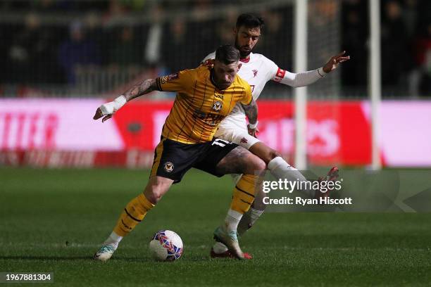 Scot Bennett of Newport County on the ball whilst under pressure from Bruno Fernandes of Manchester United during the Emirates FA Cup Fourth Round...