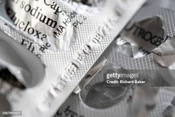 Detail of generic silver medication foils that once contained tablets, treatments and pharmaceutical products, on 31st January 2024, in London,...