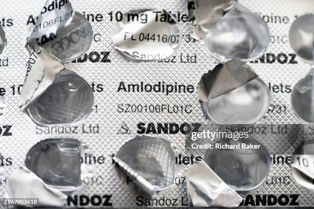 Detail of silver medication foils that once contained 10mg Amlodipine tablets, treatments and pharmaceutical products by the Sandoz brand, on 31st...